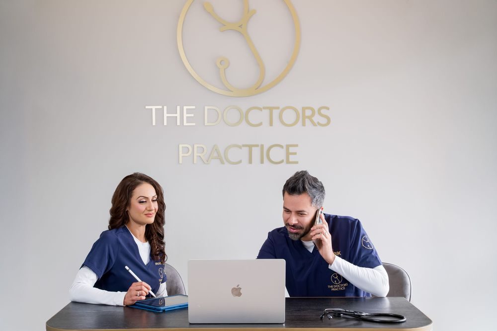 Private Health Screening Birmingham Dr Rinku and Dr Bik at reception, booking appointments at The Doctors Practice